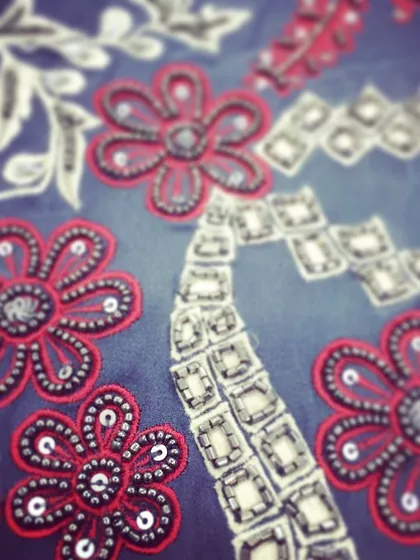 A beautiful example of katdaana beadwork. I used red thread and silver beads to create these floral motifs on a grey fabric, a stunning combination that adds intricate detail to any outfit.