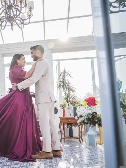 The couple shares a dance in a beautifully decorated room, with sunlight streaming in. This photo captures movement, light, and love in a single frame.