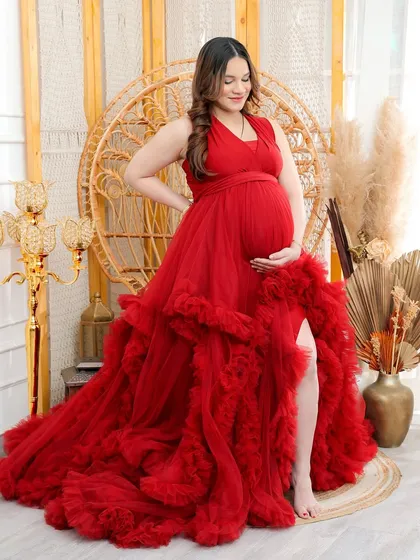 My popular ruffled red gown looks stunning when paired with the boho-chic peacock chair, creating a portrait that is both glamorous and earthy.