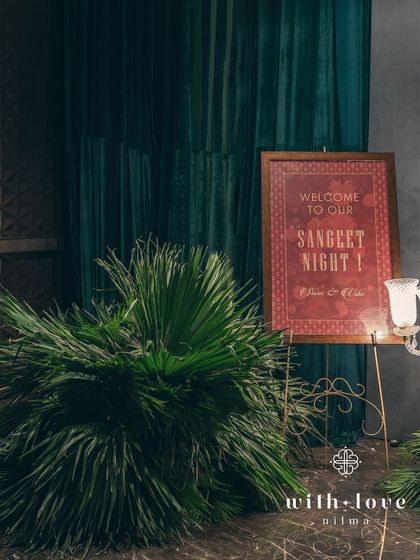 The welcome signage for the sangeet, designed with a classic font and color palette to match the elegant, art-inspired theme.