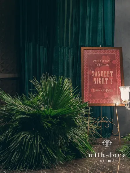 The welcome signage for the sangeet, designed with a classic font and color palette to match the elegant, art-inspired theme.