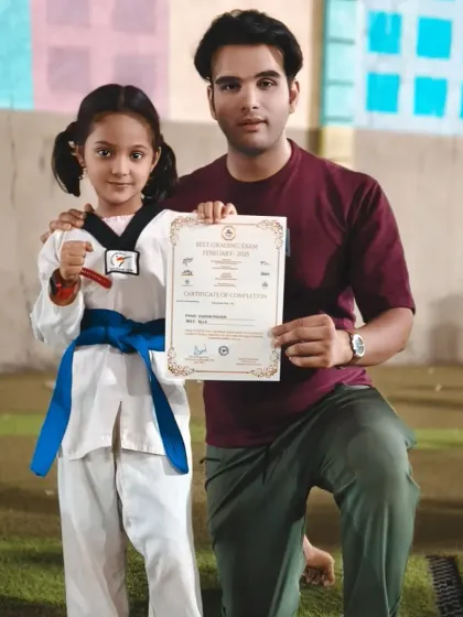 Presenting a blue belt certificate to another one of our dedicated young warriors. Congratulations on reaching this important milestone.