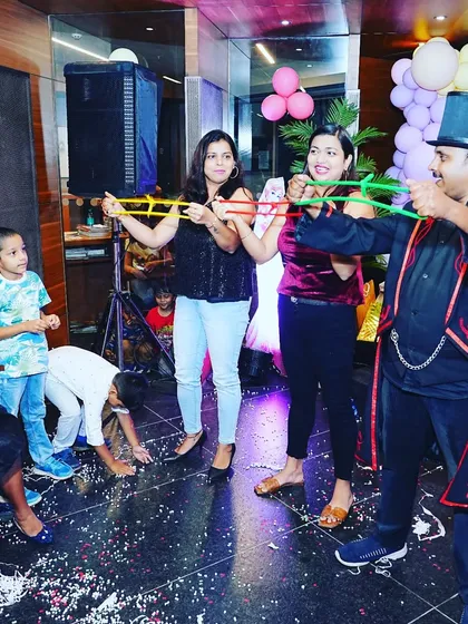 Getting the adults to participate with the classic linking rings illusion. It's always a highlight when the grown-ups are just as baffled as the kids.