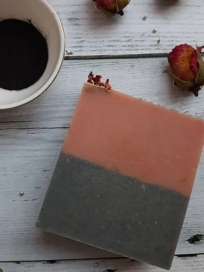 A single bar of Charcoal Rose soap, showing the simple yet elegant two-tone design. This soap is especially good for oily or combination skin, thanks to the purifying clays.