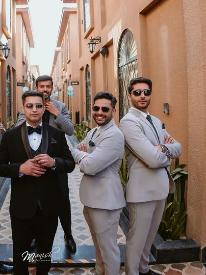 The groom and his groomsmen posing with style, a great example of creative and fun group photography.