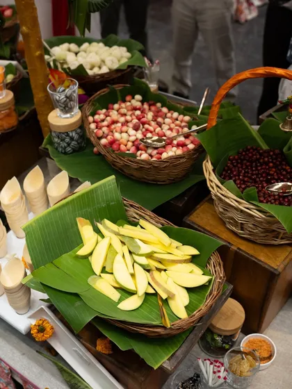 Another view of our nostalgic fruit counter, featuring raw mangoes, karonda berries, and other seasonal delights. The presentation on banana leaves adds an authentic, rustic touch.