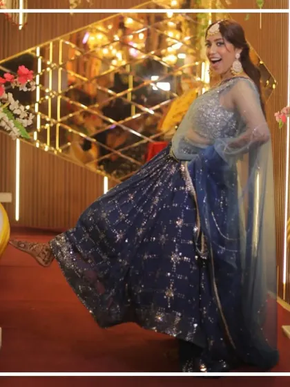A fun, playful shot of the model in the blue mehndi lehenga.