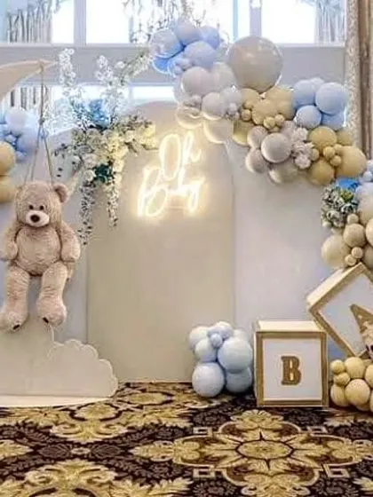 A closer look at the teddy bear on the moon prop, a popular element for celestial-themed baby showers and birthdays.