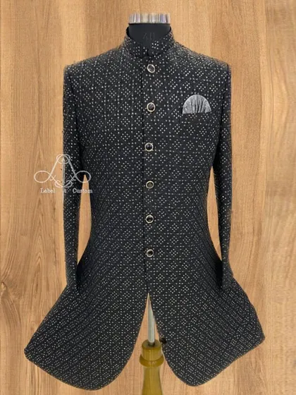 This black Bandhgala jacket features a subtle, contemporary print, giving it a unique character. Paired with a silver pocket square, it’s a great example of how a traditional garment can be styled for a modern, understated look.