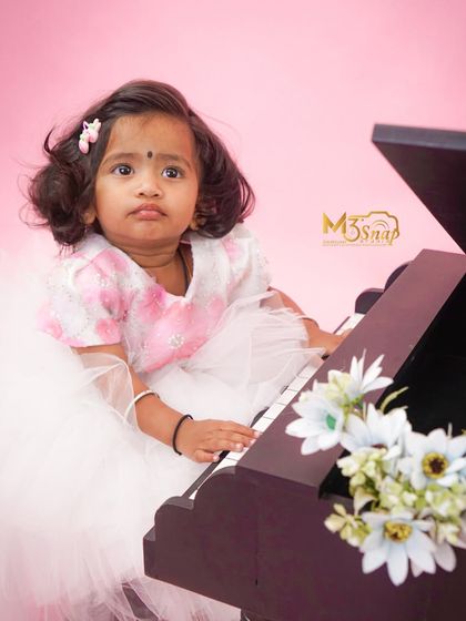 Another sweet portrait from the piano-themed session. Her thoughtful expression and tiny hands on the keys create a beautiful and artistic image.