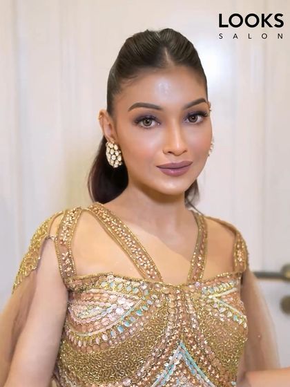 A close-up of the sleek ponytail and makeup. The look is clean, modern, and very chic, perfect for a fashion-forward client attending a special event.