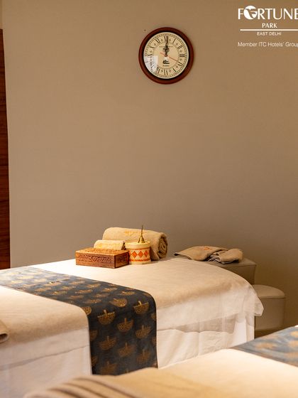 A close-up of a prepared massage bed, highlighting the fresh linens and neatly arranged accessories. I ensure every detail is perfect for your arrival.