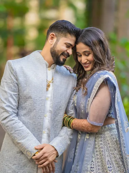 A tender moment between Saurabh and Aishwarya during their outdoor portrait session. The soft, natural lighting and their gentle interaction create a very romantic feel.