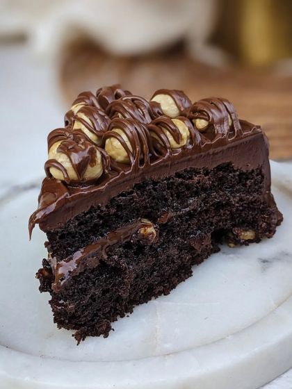 Our Nutella Hazelnut Belgian Dark Chocolate cake is a textural dream. We top our rich dark chocolate cake with a layer of Nutella, roasted hazelnuts, and more Nutella drizzle.