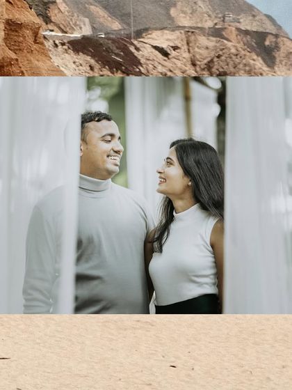 A simple, beautiful shot of a couple looking at each other, framed by sheer white curtains in an outdoor setting.