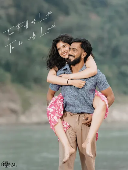 A joyful piggyback ride by the river, capturing the fun and carefree side of the couple's relationship.