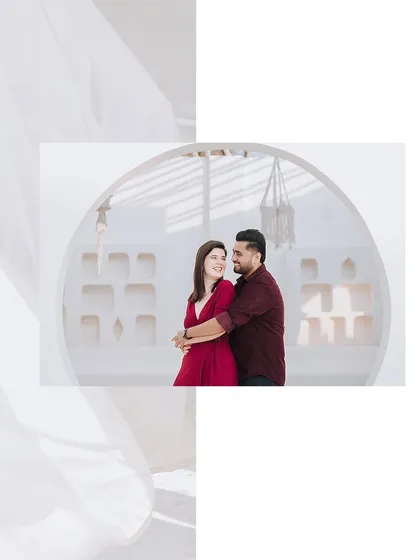 An artistic shot of the couple in a white, minimalist setting, using creative framing to create a soft and dreamy portrait.