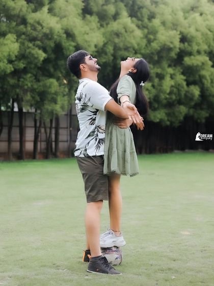 A playful and joyful lift, capturing a moment of pure happiness during a fun, football-themed pre-wedding shoot in the hills of Mussoorie.