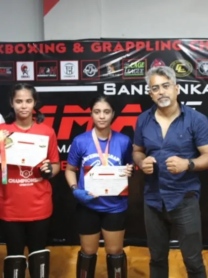Our coaches stand proudly with two more medalists from the club championship. We are a team that trains together and celebrates victories together.