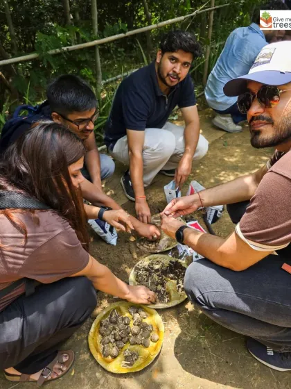 Getting your hands dirty is part of the fun! The KPMG team is fully engaged in mixing soil, compost, and seeds to create seed balls.