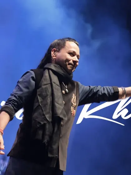 A signature portrait of Kailash Kher, capturing his smiling face and iconic style. This is the kind of shot that defines an artist's public image.