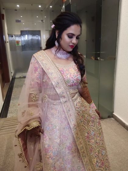 A full view of the engagement look, showing how the soft makeup complements the delicate embroidery of her outfit.