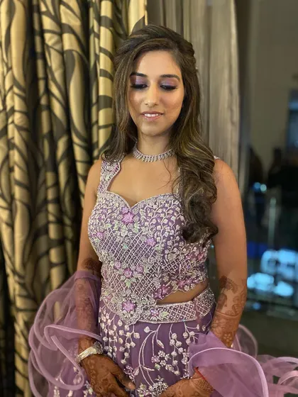 A stunning Sangeet look. The purple eyeshadow with a hint of shimmer perfectly matches her intricate lehenga.