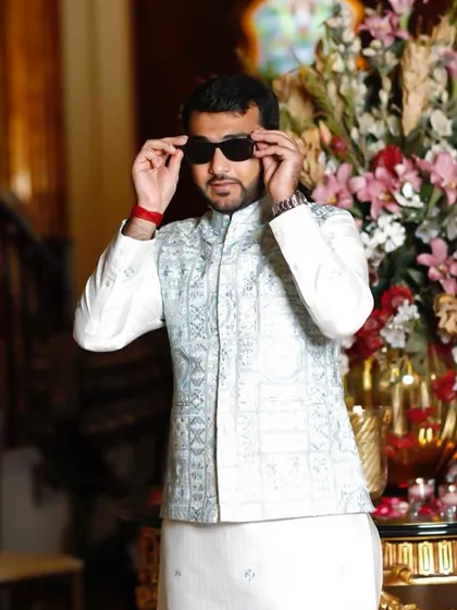 A stylish pose showing the confidence that comes with a well-fitted, elegant ethnic outfit. The sunglasses add a touch of modern flair.