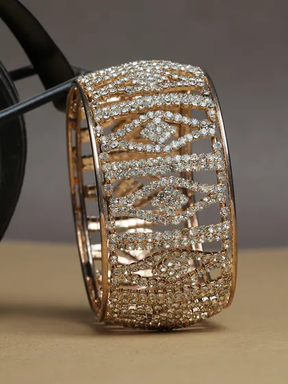 A broad, cuff-style bangle completely covered in sparkling stones.