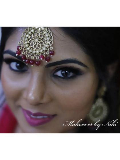 A close up portrait of Namratha. Her eyes are the star of the show, with a sharp winged liner and bold lashes.
