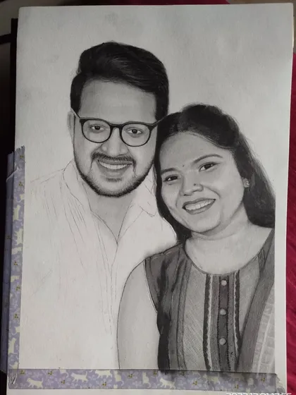 The portrait is halfway there. In this image, the woman's face and hair are nearly complete, while the man's portrait is still in the process of being shaded, showing how I work through each section.