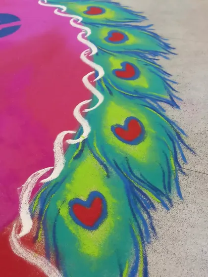A detail of the peacock feather border, where I've added small hearts for a creative touch. This shows how I can add small, custom details to make a design unique.