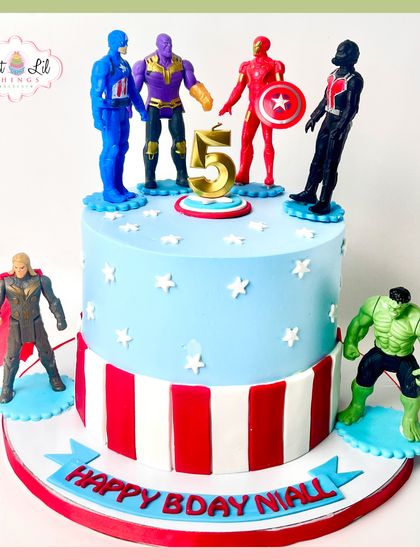 Avengers, assemble! This two-tiered superhero cake brings together the mightiest heroes, including Hulk, Thor, and Iron Man, for an epic 5th birthday celebration. The patriotic stripes add a classic comic book feel.