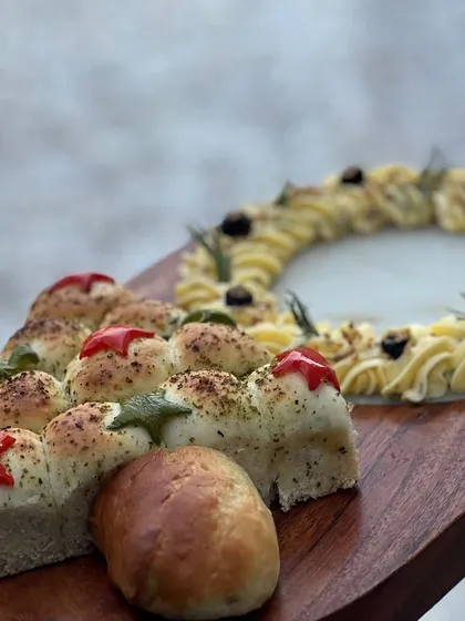 Our Christmas butter board served with a festive bell pepper pull-apart bread, a creative and interactive appetizer.