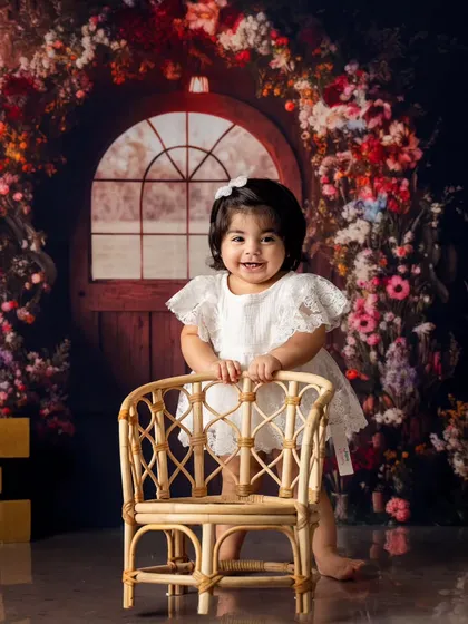 A beautiful, confident smile from the birthday girl as she stands on her own. Capturing these milestone achievements is a key part of our first birthday sessions.