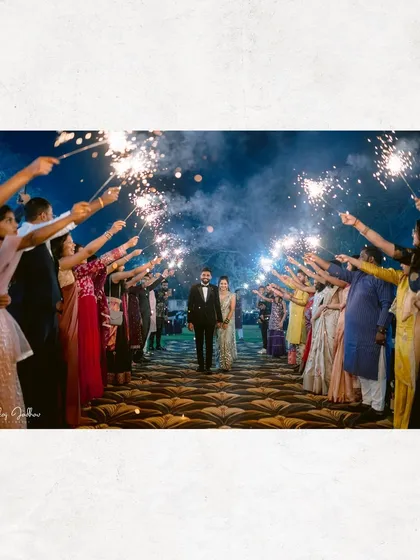 A grand entrance into a new life together. Sanket and Ruchi are framed by a tunnel of sparklers at their Sangeet, a cinematic moment filled with excitement and anticipation for the night ahead.