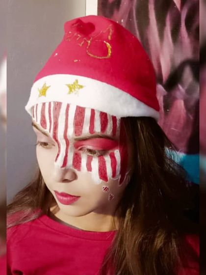 A close-up of the candy cane fantasy makeup. This highlights the student's precision in creating clean, sharp red and white stripes, a challenging but essential skill in creative makeup artistry.
