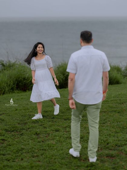 A playful "come hither" look from her as he walks towards her, creating a fun and dynamic story within the photo.