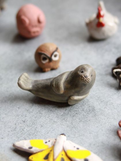 A sweet, reclining seal and a wise little owl, sculpted with care and detail by workshop participants.