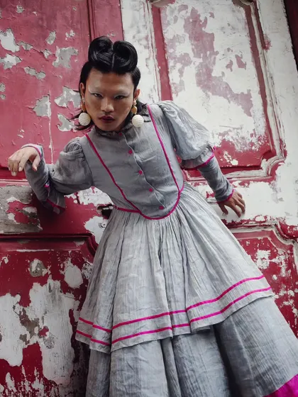 From my "RIOT" series, this image is a statement against being silenced. Set against a weathered red door, the styling and direct gaze challenge convention, creating a powerful piece of fashion storytelling that is both raw and defiant.