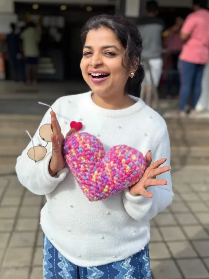Here I am, overjoyed with one of my handmade crochet hearts! I make these little charms in all sorts of colors and sizes. They are perfect as personalized gifts, keychains, or just a small token to show someone you care.