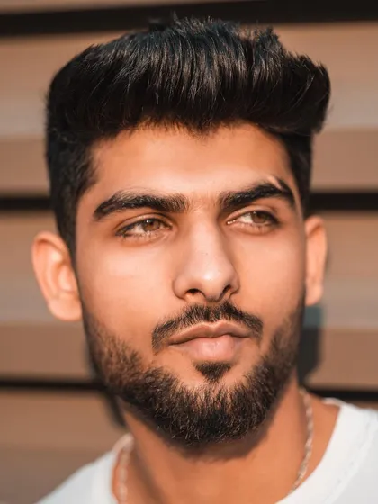 This tight headshot captures the model's features in warm, natural light. It's a clean and classic portrait that showcases his potential for commercial and print work.