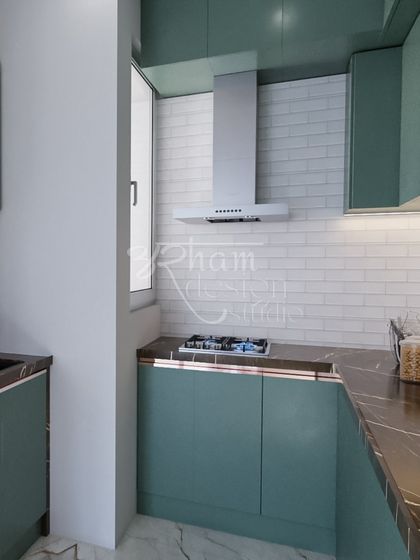 This kitchen design was inspired by my client's love for subtle green. We created a highly functional space with custom cabinetry that feels both trendy and timeless, complete with a classic white brick-style backsplash.