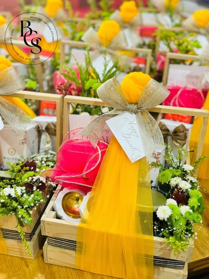 A beautiful display of Diwali hampers in wooden crates, filled with flowers and gifts. This image shows my ability to create stunning, large-scale festive displays for events or corporate dispatch.