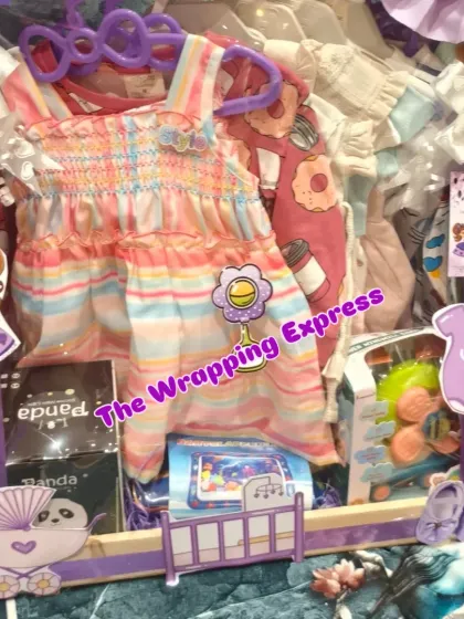 Another view of the princess-themed baby hamper, showing the collection of colorful clothes, toys, and baby shoes.