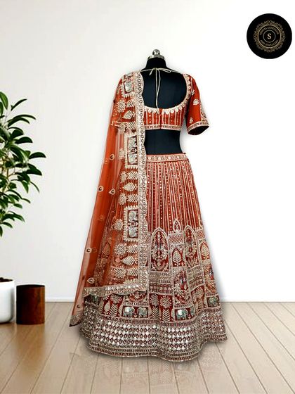 This rust-orange lehenga with intricate silver gota patti work is a unique and beautiful choice for a day wedding or Anand Karaj ceremony.