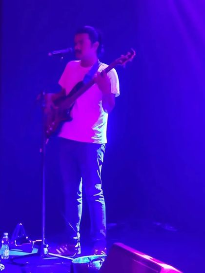 Our bassist performing under the cool blue lights at the Four Seasons corporate event.