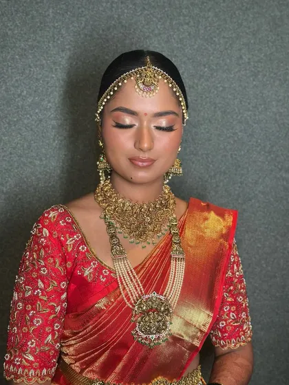A close-up portrait focusing on the beautiful, soft-glam eye makeup and the perfectly applied base.