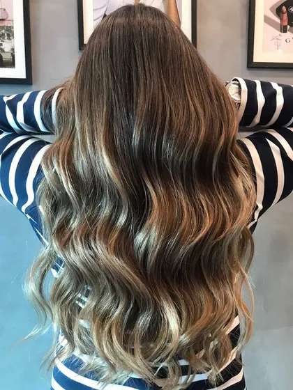 My signature balayage transformation using a freelights technique. This method allows for a soft, natural-looking highlight that gives a shimmery, sun-kissed glow.
