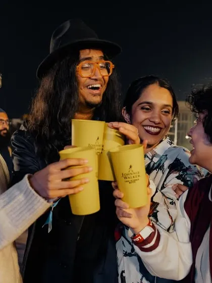 Happy fans toasting at a Jacob Collier concert, capturing the joyful atmosphere of the event.